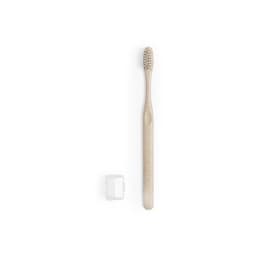 A light-coloured toothbrush with a textured head and a small, white protective cap beside it.
