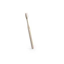 A toothbrush with a beige handle and white bristles, featuring a simple design. It has a branding logo on the handle.