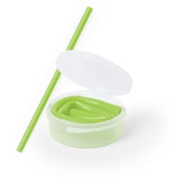 A drink container with a green silicone straw and a white lid. The straw is also green.
