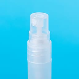 A clear hand sanitiser bottle with a spray nozzle, set against a blue background.