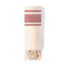 A bath towel in cream with red stripes and fringed edges, featuring a logo.