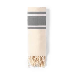 A bath towel in cream and grey, featuring striped patterns and decorative tassels at one end.