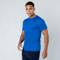 A blue Markus T-Shirt displayed by a model, featuring short sleeves and a logo on the bottom.