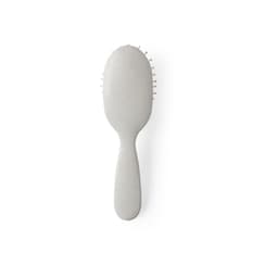 A grey hairbrush with a rounded handle and flexible bristles, featuring a minimalist design.