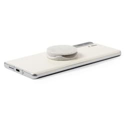 A white phone stand with a round base rests on a sleek, silver smartphone. The product has a logo on its surface.