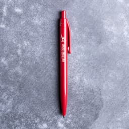 A red plastic pen with a clip and a branding logo on the side.