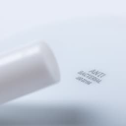 A drinking straw in white with an antibacterial feature, featuring a branding logo on the side.