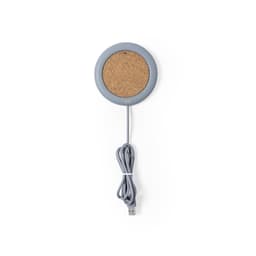 A wireless charger with a grey circular edge and a cork top, featuring a grey USB cable attached.