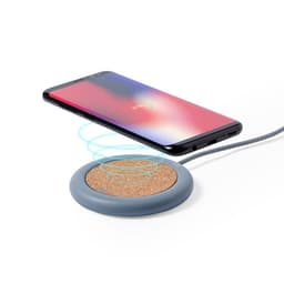 A wireless charger with a cork surface and a grey base, alongside a smartphone displaying a charging indicator.