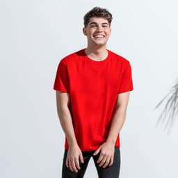 A red adult t-shirt displayed on a smiling model, featuring a simple design and casual fit. It has a logo.