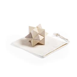A wooden puzzle made of interlocking triangular pieces, resting on a beige fabric pouch.