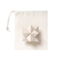 A wooden puzzle featuring geometric shapes, presented in a cream-coloured drawstring bag.