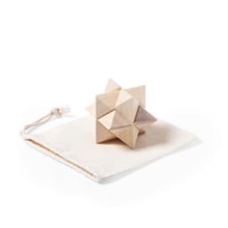 A wooden puzzle game in light shades, resting on a soft beige bag with a drawstring. The product features a geometric design.