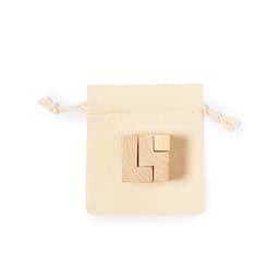 A wooden puzzle featuring interlocking pieces, placed on a natural fabric drawstring pouch.