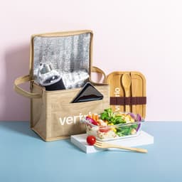 A cooler bag in beige with a logo, containing a drink bottle, phone, utensils, and a salad in a glass container.