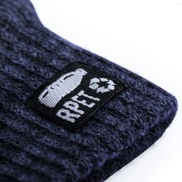 A textured navy glove featuring a black logo patch. The fabric appears soft and ribbed.