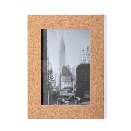 A cork photo frame featuring a black-and-white image of the Chrysler Building and classic cars. It has a logo.