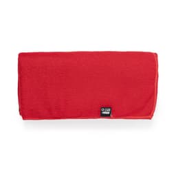A red absorbent towel with a textured surface and a small logo at one corner.