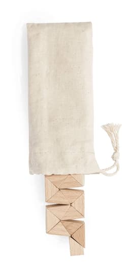 A set of wooden triangular blocks in a cotton bag. The blocks are a natural wood colour, with a light fabric cover.