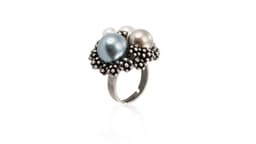 A silver adjustable ring featuring blue, grey, and white pearls surrounded by small metal beads.