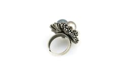 A silver adjustable ring featuring three decorative pearls in blue, white, and grey.