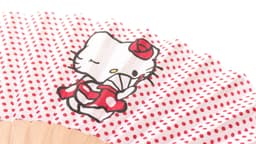 A red polka-dotted hand fan featuring a cartoon character, with wooden ribs and a playful design.