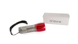 A silver torch with a red top, accompanied by a grey box, and featuring a wrist strap.