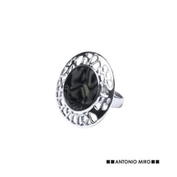 A silver ring with a circular design and a dark, reflective centre, featuring an intricate cut-out pattern.