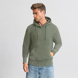 A green hoodie with a front pocket and drawstring, worn by a model against a neutral background.