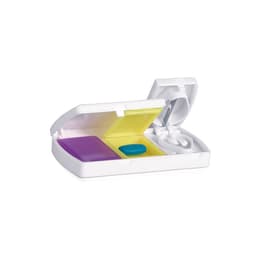A pillbox in white includes compartments in yellow and purple, with a blue pill and a small white tablet.