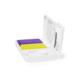 A white pillbox featuring two compartments, one purple and one yellow, with a small cutting tool inside.