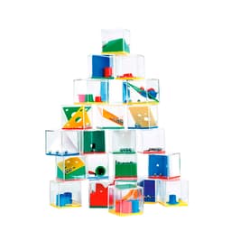 A collection of clear containers in various colours filled with colourful shapes and small balls, arranged in a tower.