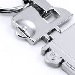 A silver trailer keyring with a metallic finish, featuring a detailed design and a keyring attachment.