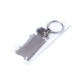 A metallic trailer keyring featuring a sleek design and attached keyring, enclosed in a clear plastic packaging.