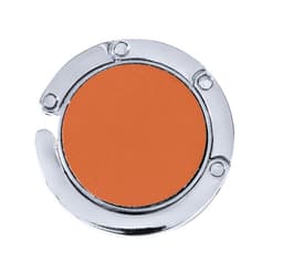 A round, foldable bag hanger in orange with a chrome finish, featuring a logo on the surface.