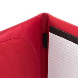 A red compendium with a lined notepad and a black elastic holder inside. It features a smooth, textured finish.