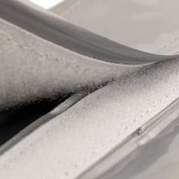 A drink bottle cooler featuring a grey exterior with a velcro closure and a soft inner lining.