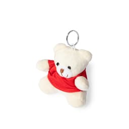 A cream teddy bear keyring wearing a red shirt, with a metal keyring attached. It has a small, friendly face.