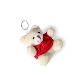 A cream teddy bear keyring wearing a red outfit, complete with a silver keyring attachment.