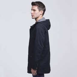 A twill jacket in navy blue featuring a hood, side pockets, and a grey inner lining. It has a logo on the front.