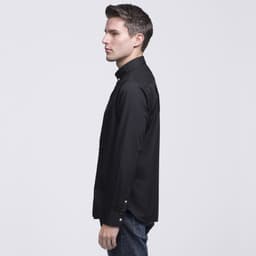 A button-up shirt in black, displayed on a model from the side, featuring a collar and long sleeves.