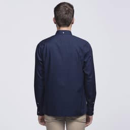A navy blue button-up shirt with a classic collar and long sleeves, featuring a logo. Back view is shown.