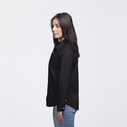 A black button-up shirt with a collared design, featuring a logo, displayed on a model from the side.