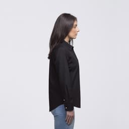 A black button-up shirt displayed on a woman from the side, featuring a collar and a slim fit.