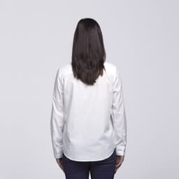 A white button-up shirt viewed from the back, featuring long sleeves and a simple design.
