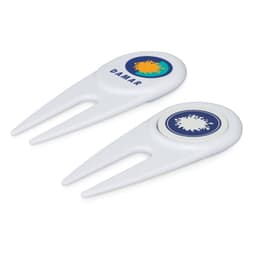 A white golf divot repairer with a marker, featuring circular designs and a logo on each side.