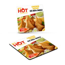 A square fridge magnet featuring golden samosas, garnished with herbs, in vibrant colours. It has a logo and promotional text.