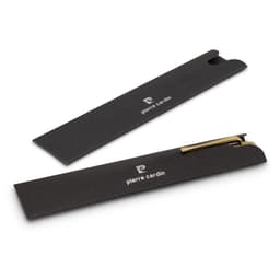 A metal pen with a sleek gold finish, displayed within a black case featuring branding.