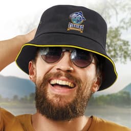 A black bucket hat featuring a logo and a coloured sandwich trim, modelled by a smiling person wearing sunglasses.