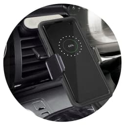 A black wireless charging phone holder mounted on a car dashboard, with a phone displaying a charging indicator.